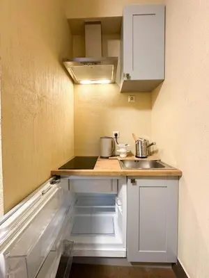 a small kitchen with a counter and a sink at New Town Home 2 in Vilnius