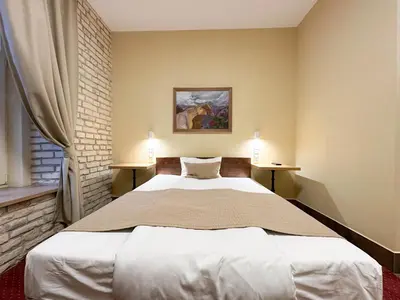 a bedroom with a large bed with two night stands at New Town Home 2 in Vilnius