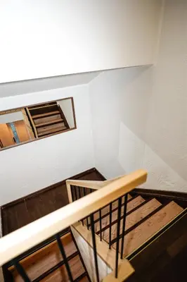 an empty room with stairs and a window at Garden Cottage in Šiauliai