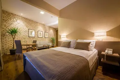 a bedroom with a bed and a table and chairs at New Town Home 3 in Vilnius