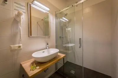 a bathroom with a sink and a shower at New Town Home 3 in Vilnius