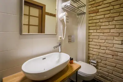 a bathroom with a white sink and a toilet at New Town Home 3 in Vilnius