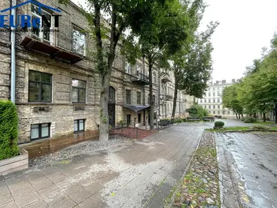 an empty street in front of a brick building at New Town Home in Vilnius