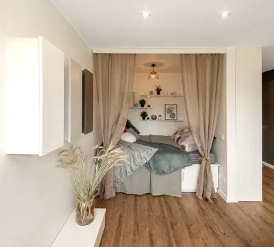 a bedroom with a bed and curtains in a room at Sunshine apartamentai in Alytus