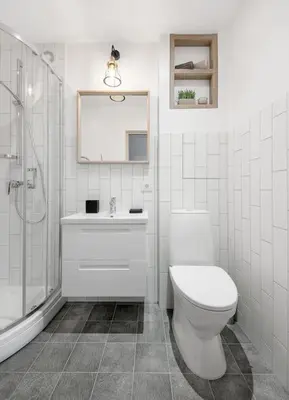 a bathroom with a toilet and a sink and a shower at Sunshine apartamentai in Alytus