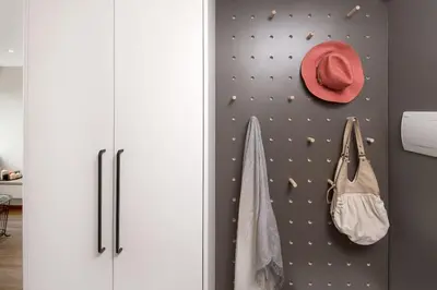 a room with a wall with a hat and bags at Sunshine apartamentai in Alytus