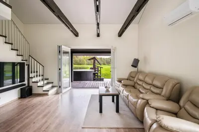 a living room with a couch and a table at Vila Valentino in Klepšiai