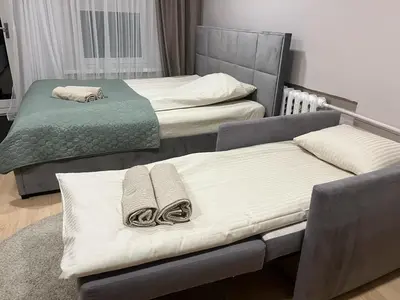 two beds in a room with towels on them at Kakava House in Nemėžis