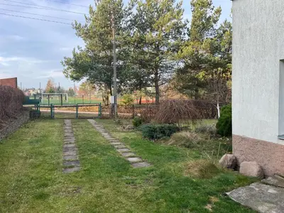 a garden with a stone path in the grass at Kakava House in Nemėžis