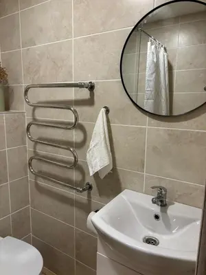 a bathroom with a sink and a mirror at Kakava House in Nemėžis