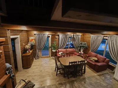 a living room with a table and a couch at Užmiesčio trobelė in Mackėnai