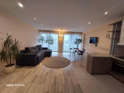 a living room with a couch and a table at four room's apartments in Vilnius