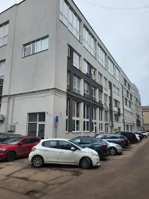 a white car parked in front of a building at four room's apartments in Vilnius