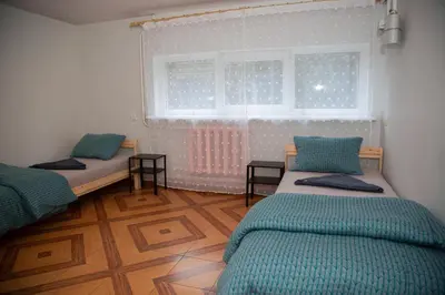 a room with two beds and a window at Azimut Guest House Quiet Getaway Garden Sauna in Šiauliai