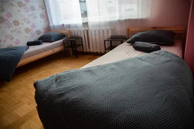 two twin beds in a room with a window at Azimut Guest House Quiet Getaway Garden Sauna in Šiauliai