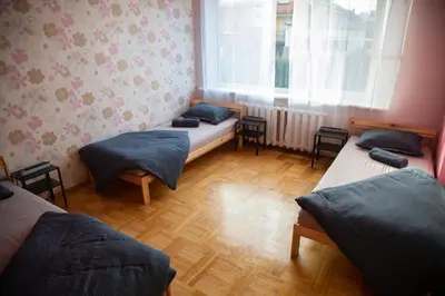 a room with two twin beds and a window at Azimut Guest House Quiet Getaway Garden Sauna in Šiauliai