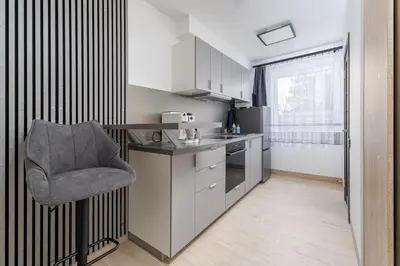 a small kitchen with a chair and a counter at Rasytes 10 in Kaunas