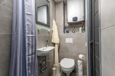 a small bathroom with a toilet and a sink at Rasytes 10 in Kaunas