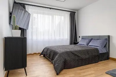 a bedroom with a bed and a large window at Rasytes 10 in Kaunas