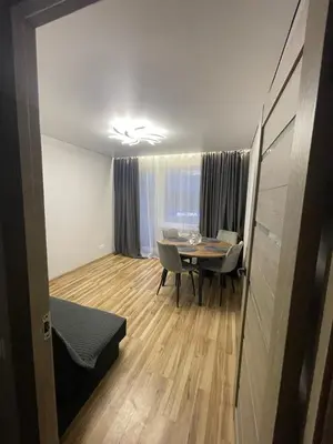 a living room with a table and a dining room at Jaukus butas Jonavoje in Jonava