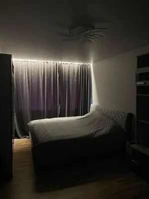 a bedroom with a bed and a window with curtains at Jaukus butas Jonavoje in Jonava