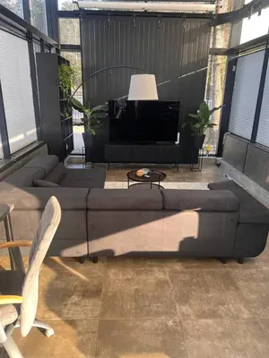 a living room with a couch and a piano at Aquaspot Kaunas in Kaunas