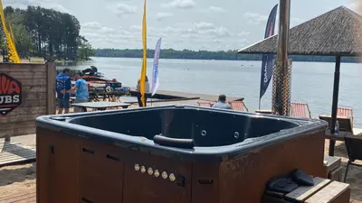 a large blue tub sitting on the shore of a body of water at Aquaspot Kaunas in Kaunas