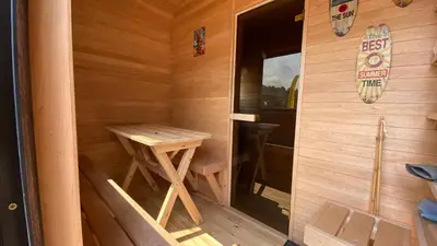 a small wooden sauna with a table in it at Aquaspot Kaunas in Kaunas