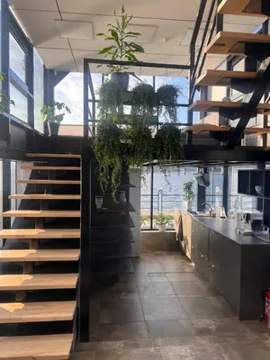 a staircase in a room with potted plants at Aquaspot Kaunas in Kaunas
