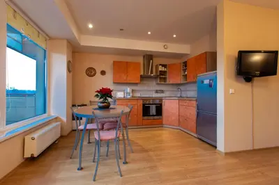 a kitchen with a table and a blue refrigerator at DJ home in Druskininkai
