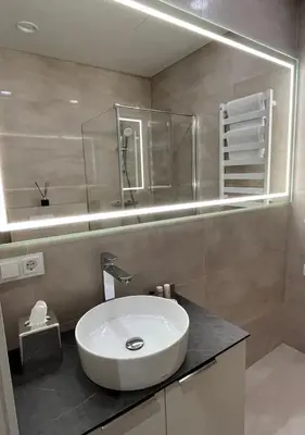 a bathroom with a white sink and a mirror at Maironio apartamentai in Kaunas