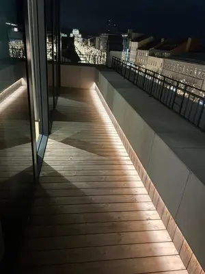 a balcony with a view of the city at night at Maironio apartamentai in Kaunas