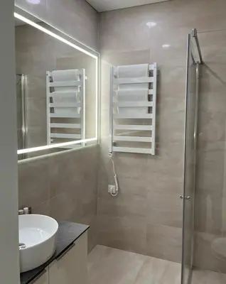 a bathroom with a sink and a shower and a mirror at Maironio apartamentai in Kaunas