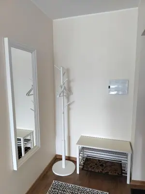 a white room with a mirror and a table and a mirror at Apartamentai dviems Ignalinoje in Ignalina