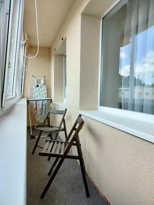 a room with a chair and a window at Apartamentai dviems Ignalinoje in Ignalina