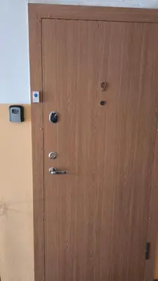 a wooden door with metal knobs on it at Apartamentai dviems Ignalinoje in Ignalina
