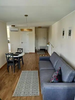 a living room with a couch and a table at Apartamentai dviems Ignalinoje in Ignalina