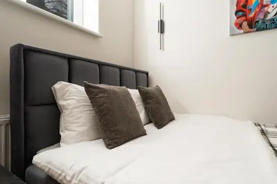 a bed with two pillows on top of it at Studio Chic in Vilnius