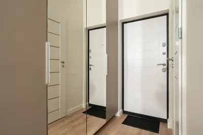 a bathroom with a glass door and a mirror at Studio Chic in Vilnius