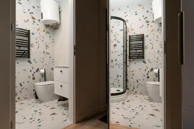 a bathroom with two toilets and a shower at Studio Chic in Vilnius