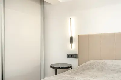a bedroom with a bed and a side table at Cozy loft in city center in Vilnius