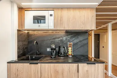 a kitchen with a sink and a microwave at Cozy loft in city center in Vilnius
