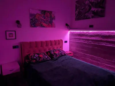 a bedroom with a bed in a pink room at Panoramic view home in Kaunas