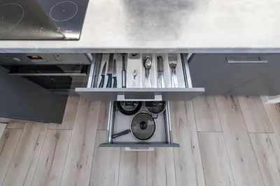 a kitchen with a washing machine under a counter at Shanti barracks apartment #2 by Polo Apartments in Kaunas