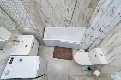 a white bathroom with a sink and a toilet at Shanti barracks apartment #2 by Polo Apartments in Kaunas