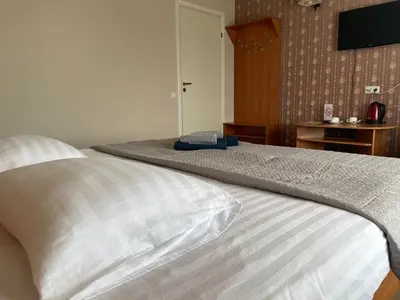 a bedroom with a bed with a pillow and a television at Žilina in Marijampolė
