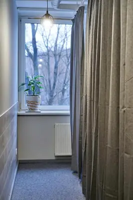 a window with a potted plant on a window sill at Tokyo Vibes - Private Sleeping Pods Hostel, Self check-in in Vilnius