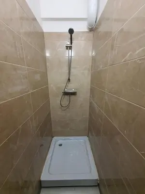 a bathroom with a shower with a toilet in it at Tokyo Vibes - Private Sleeping Pods Hostel, Self check-in in Vilnius