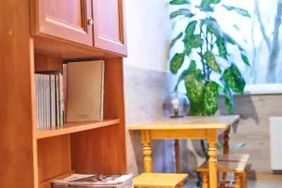 a book shelf with a table in a room at Tokyo Vibes - Private Sleeping Pods Hostel, Self check-in in Vilnius