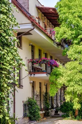 a building with balconies and flowers on it at Spacious, Very cosy, Stylish and Perfectly located in Vilnius